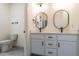 Bathroom with double vanity, dual modern mirrors, white cabinets and black hardware at 20 Tamaran Ct, Spring Hope, NC 27882
