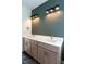 Bathroom featuring double vanity, designer fixtures, and an accent wall at 20 Tamaran Ct, Spring Hope, NC 27882