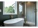 Bathroom featuring modern tub, shower with glass doors, and a window for natural light at 20 Tamaran Ct, Spring Hope, NC 27882