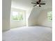 Spacious bedroom featuring plush carpet, ceiling fan, and two windows with natural light at 20 Tamaran Ct, Spring Hope, NC 27882