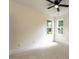 Bright bedroom features plush carpeting, a ceiling fan, and natural light from windows at 20 Tamaran Ct, Spring Hope, NC 27882