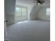 Bright bedroom with neutral carpet, angled ceilings, ceiling fan, and multiple windows at 20 Tamaran Ct, Spring Hope, NC 27882