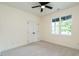 Bright bedroom features plush carpeting, a ceiling fan, and natural light from the window at 20 Tamaran Ct, Spring Hope, NC 27882