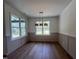 Bright dining room with large windows, hardwood floors, and decorative lighting fixture at 20 Tamaran Ct, Spring Hope, NC 27882