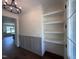 Open entryway with floating shelves, wainscoting, and hardwood floors at 20 Tamaran Ct, Spring Hope, NC 27882