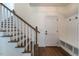 Bright entryway featuring hardwood floors, coat rack, and staircase with hardwood trim at 20 Tamaran Ct, Spring Hope, NC 27882