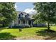 Charming two-story home with a welcoming front porch, green lawn and mature trees at 20 Tamaran Ct, Spring Hope, NC 27882