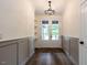 Elegant foyer with hardwood floors, wainscoting, and stylish lighting fixtures at 20 Tamaran Ct, Spring Hope, NC 27882