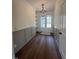 Welcoming foyer with hardwood floors, stylish lighting fixture, and convenient built-in shelving and closet at 20 Tamaran Ct, Spring Hope, NC 27882