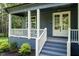 Inviting front porch with white railing, stylish double doors, and manicured bushes at 20 Tamaran Ct, Spring Hope, NC 27882