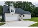 View of attached two car garage and parking area at 20 Tamaran Ct, Spring Hope, NC 27882