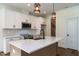 Bright kitchen features white cabinets, an island with a sink, and stainless steel appliances at 20 Tamaran Ct, Spring Hope, NC 27882