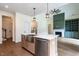 Open kitchen with large island, stainless steel sink, and view of the living room at 20 Tamaran Ct, Spring Hope, NC 27882