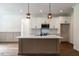 Kitchen with white cabinets, island, stainless appliances and stylish pendant lighting at 20 Tamaran Ct, Spring Hope, NC 27882