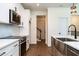Kitchen showcasing stainless steel sink, appliances, white cabinets, and modern fixtures at 20 Tamaran Ct, Spring Hope, NC 27882