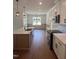 Modern kitchen featuring a large island, stainless steel appliances, white cabinets, and stylish pendant lighting at 20 Tamaran Ct, Spring Hope, NC 27882