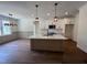 Bright kitchen featuring a large island, stylish pendant lighting, and modern appliances including stainless steel microwave at 20 Tamaran Ct, Spring Hope, NC 27882