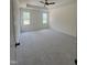 Spacious main bedroom featuring plush carpeting, tray ceiling, and natural light from dual windows at 20 Tamaran Ct, Spring Hope, NC 27882