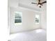 A spacious main bedroom with a ceiling fan and natural light from two windows at 20 Tamaran Ct, Spring Hope, NC 27882