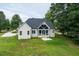 Aerial showing rear of home with screened-in porch and surrounding greenery at 20 Tamaran Ct, Spring Hope, NC 27882