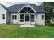 View of the home's rear exterior, highlighting a screened-in porch and well-maintained lawn at 20 Tamaran Ct, Spring Hope, NC 27882