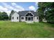 Back exterior view of home featuring a screened porch and well-manicured lawn at 20 Tamaran Ct, Spring Hope, NC 27882