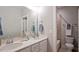 Bathroom featuring a double vanity, quartz countertop, modern fixtures, and tiled shower at 224 Wash Hollow Dr, Wendell, NC 27591