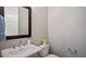 Elegant powder room featuring a pedestal sink, dark wood framed mirror and neutral decor at 224 Wash Hollow Dr, Wendell, NC 27591