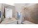 Bathroom with modern vanity, countertop and large mirror and tiled tub and shower at 224 Wash Hollow Dr, Wendell, NC 27591
