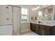 Bathroom with double vanity, granite counters, and glass shower doors, featuring natural light at 224 Wash Hollow Dr, Wendell, NC 27591