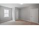 Bright bedroom with neutral walls, carpet, white trim, a window and two doors at 224 Wash Hollow Dr, Wendell, NC 27591