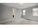 Bedroom featuring neutral carpet, two windows, and connecting door to the bathroom at 224 Wash Hollow Dr, Wendell, NC 27591