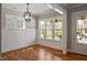 Bright dining room with hardwood floors, modern light fixture and large windows for natural light at 224 Wash Hollow Dr, Wendell, NC 27591