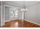 Bright dining room with hardwood floors, modern chandelier, and a view of the patio at 224 Wash Hollow Dr, Wendell, NC 27591