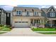 Charming two-story home with a welcoming front porch, two car garage, and a beautifully manicured front yard at 224 Wash Hollow Dr, Wendell, NC 27591