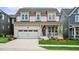 Charming two-story home with a well-manicured lawn, garage, and welcoming front porch at 224 Wash Hollow Dr, Wendell, NC 27591