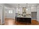 Modern kitchen featuring white cabinets, stainless steel appliances, and an island with seating at 224 Wash Hollow Dr, Wendell, NC 27591