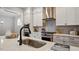 Close up of the sink in the kitchen island with pendant lighting and stainless appliances at 224 Wash Hollow Dr, Wendell, NC 27591