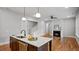 Open concept home with kitchen island, modern appliances, and view of the living area at 224 Wash Hollow Dr, Wendell, NC 27591