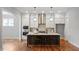Bright kitchen featuring an island with bar seating, modern appliances and fixtures at 224 Wash Hollow Dr, Wendell, NC 27591