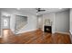 Spacious living room featuring a fireplace, hardwood floors, a staircase, and ample natural light at 224 Wash Hollow Dr, Wendell, NC 27591
