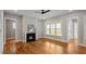 Inviting living room with hardwood floors, a fireplace, and natural light from large windows at 224 Wash Hollow Dr, Wendell, NC 27591