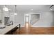 Open-concept layout with hardwood floors, white cabinets, and a staircase leading upstairs at 224 Wash Hollow Dr, Wendell, NC 27591