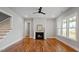 Bright living room featuring a fireplace, hardwood floors, and a staircase leading upstairs at 224 Wash Hollow Dr, Wendell, NC 27591