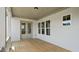 Covered porch with wood flooring, white trim, and ample natural light from surrounding windows at 224 Wash Hollow Dr, Wendell, NC 27591