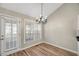 Bright dining area with hardwood floors, chandelier, and access to patio at 2773 Clifton Avenue, Creedmoor, NC 27522