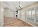 Open dining area with hardwood floors, chandelier, and view of living room at 2773 Clifton Avenue, Creedmoor, NC 27522