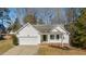 Charming one-story home with a white exterior, two-car garage and landscaped yard at 2773 Clifton Avenue, Creedmoor, NC 27522