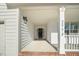 Inviting front porch with white columns and brick flooring at 2773 Clifton Avenue, Creedmoor, NC 27522
