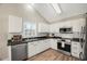 Modern kitchen with stainless steel appliances and white cabinets at 2773 Clifton Avenue, Creedmoor, NC 27522